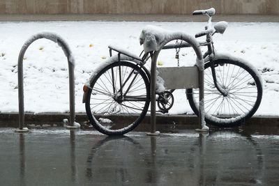 Bicycle covered with snow on the street during  season