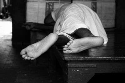 Man sleeping on wooden table