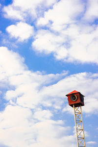 Low angle view of telephone pole against sky