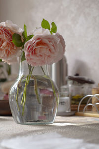 Close-up of pink roses in vase on table