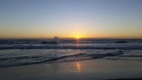 Scenic view of sea against clear sky during sunset