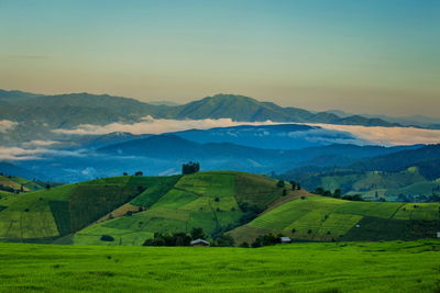 High angle view of field and mountains against sky