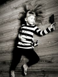 Cute girl playing on wood