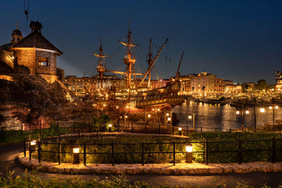 Illuminated buildings against sky at night
