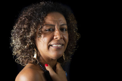 Portrait of an afro descendant model against black background. 