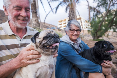 Senior couple sitting with dogs