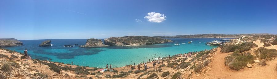 Panoramic view of beach against clear blue sky