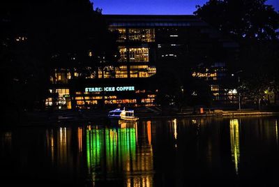 Reflection of buildings in water at night