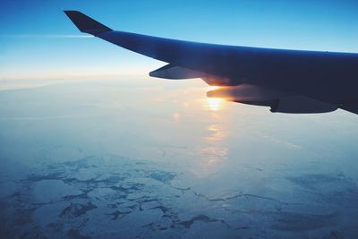 Cropped image of airplane flying over landscape