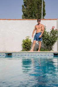 Full length of shirtless man in swimming pool