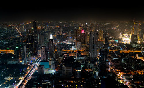 High angle view of illuminated city buildings at night