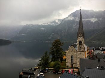 Church by lake against mountain