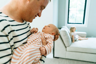 Cropped closeup portrait of a father holding a baby girl