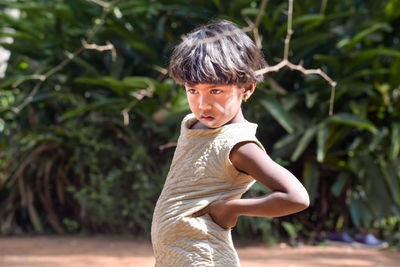 Side view of woman sitting on field