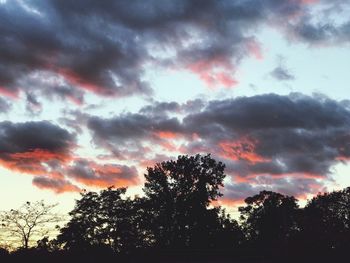 Low angle view of silhouette trees against sky at sunset