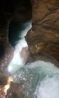 Scenic view of river flowing through cave