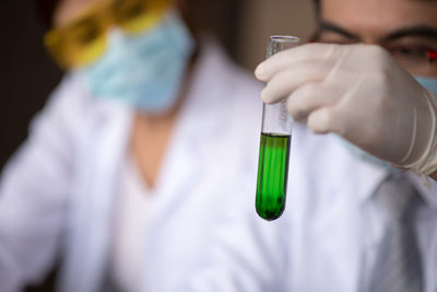 Man and woman performing experiment in laboratory