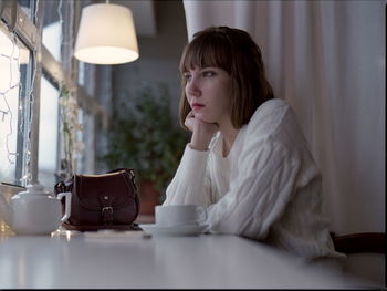 Young woman sitting on table