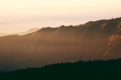 Scenic view of silhouette mountains against sky during sunset