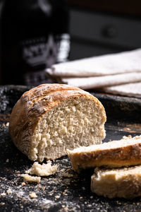 Baked homemade bread on black and wooden background, bakery setting