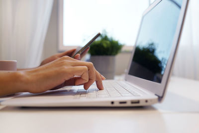 Midsection of woman using mobile phone