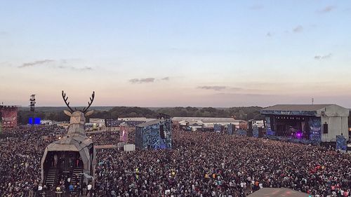 High angle view of people in city against sky during sunset