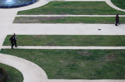 High angle view of people walking on footpath