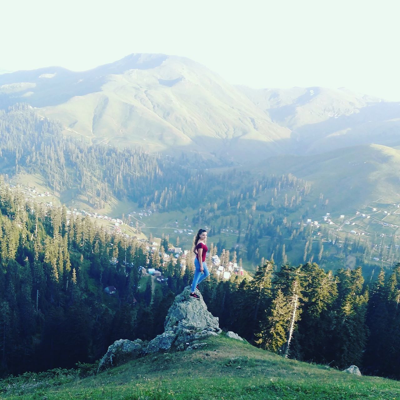 mountain, beauty in nature, nature, scenics, mountain range, one person, day, outdoors, tranquil scene, rear view, real people, landscape, full length, tranquility, leisure activity, standing, tree, young adult, sky, people