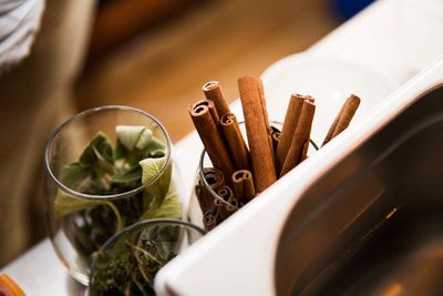 Glass of cinnamon sticks and leaves