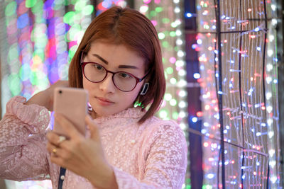 Portrait of woman using mobile phone outdoors