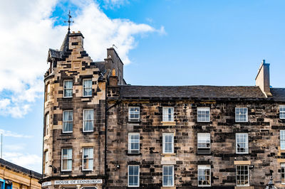 Low angle view of building against cloudy sky