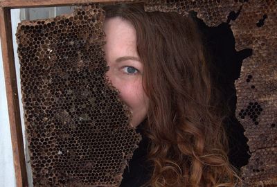 Portrait of woman with dried beehive