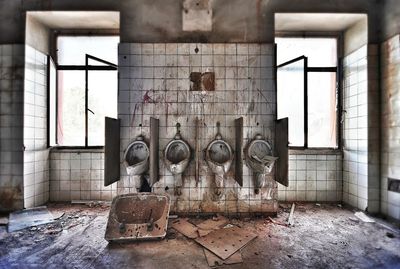 Damaged urinals in abandoned building