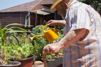 Side view of man working on plant