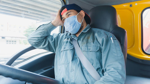 Midsection of man sitting in car