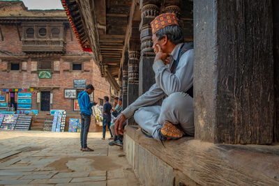 People sitting outside building