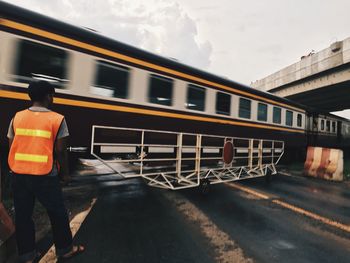 Rear view of train on road in city against sky