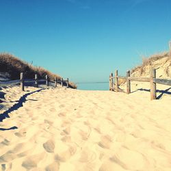 View of beach against clear blue sky