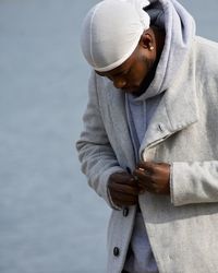 Man wearing jacket while standing at beach