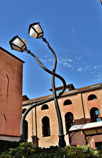 Low angle view of street light against building