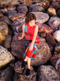 Full length of woman standing on rocks