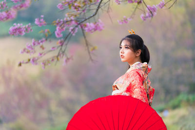 Beautiful female wearing traditional japanese kimono with cherry blossom in spring, japan.