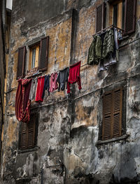 Low angle view of clothes drying outside building