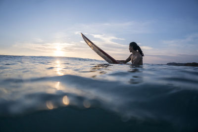 Mid twenties man surfing near punta de mita, mexico