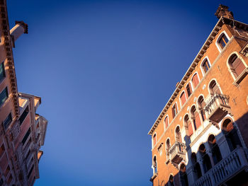 Low angle view of building against blue sky