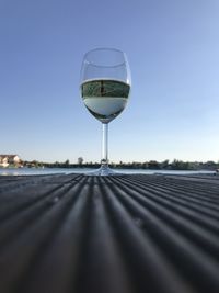 Close-up of beer glass against clear sky