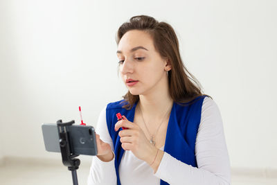 Young woman vlogging at studio