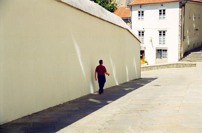 Rear view of man walking in building