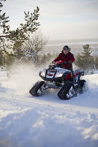 Man riding quad at winter