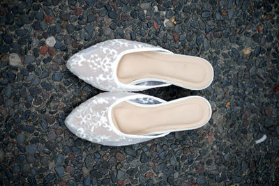 Low section of white shoes on street